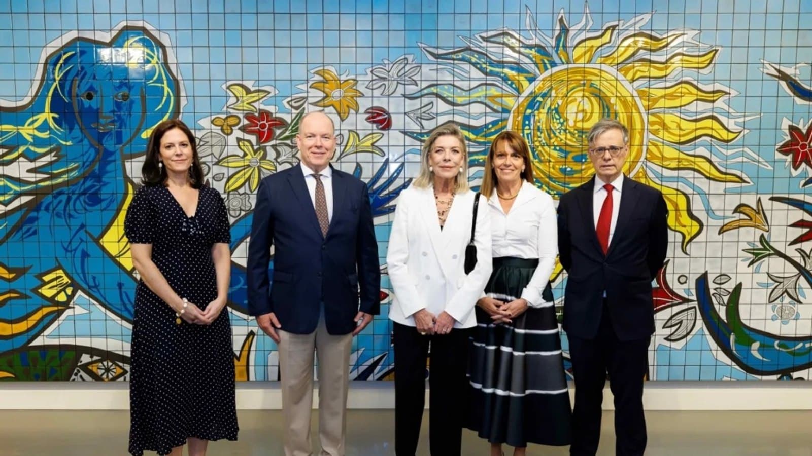 Prince Albert II, the Princess of Hanover and officials standing in front of a colourful mosaic mural at the inauguration of the Memoire des Lieux exhibition.